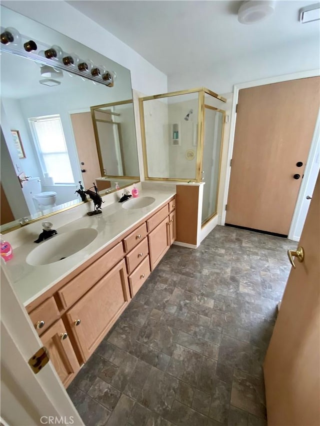 bathroom featuring walk in shower, vanity, and toilet