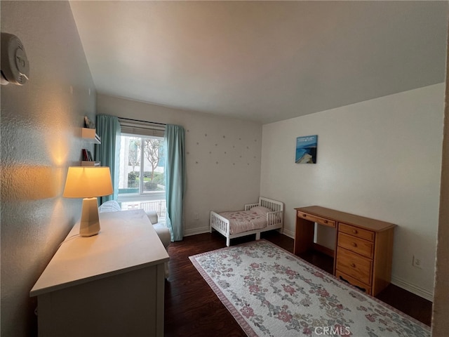 bedroom with dark hardwood / wood-style floors