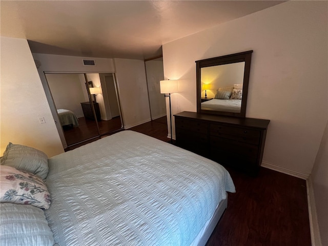 bedroom featuring a closet and dark hardwood / wood-style flooring