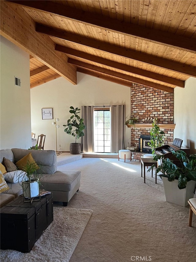 living room with carpet floors, vaulted ceiling with beams, visible vents, a brick fireplace, and wooden ceiling