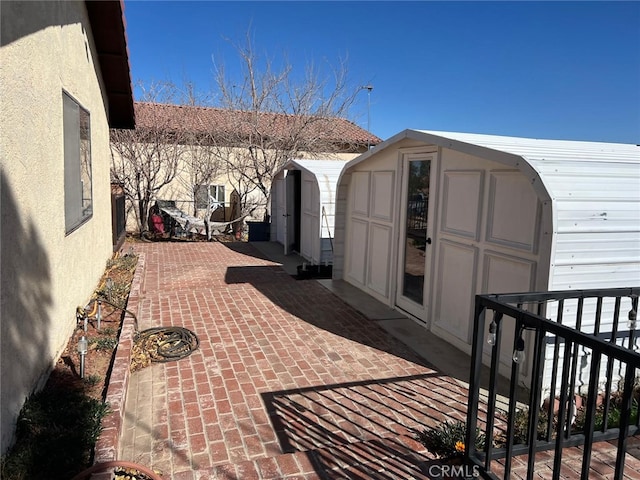 view of patio with a storage shed, an outdoor structure, and fence