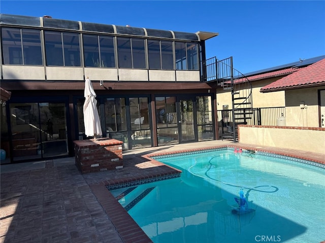 pool with a patio and stairs