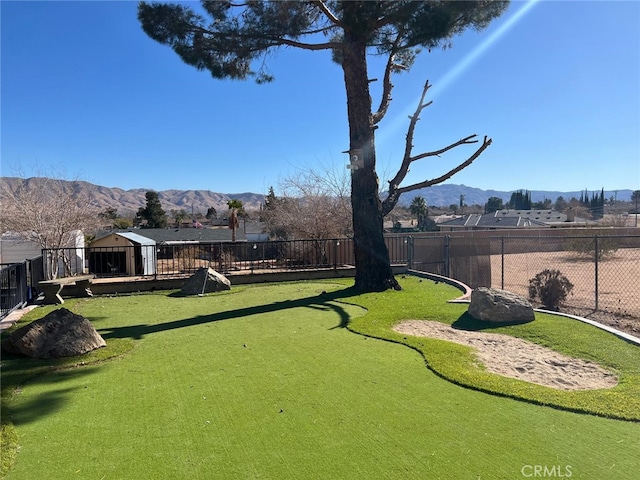 view of property's community with a fenced backyard and a mountain view