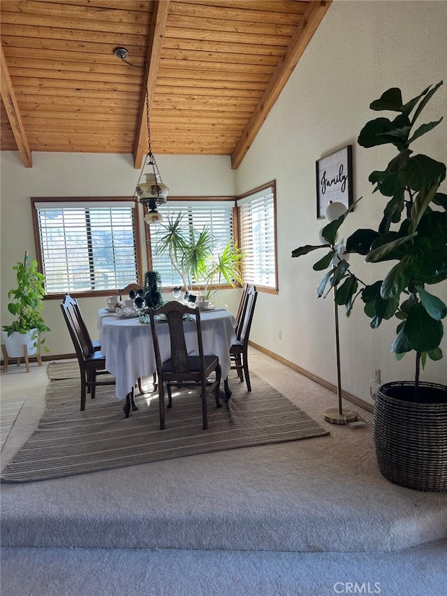 dining space with lofted ceiling with beams, wooden ceiling, carpet, and baseboards