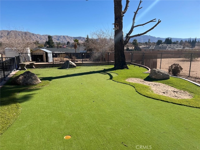 view of yard with fence and a mountain view