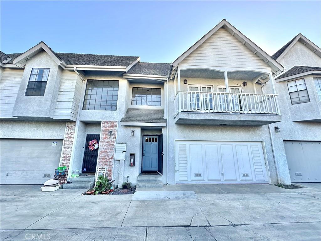 view of property with a balcony and a garage