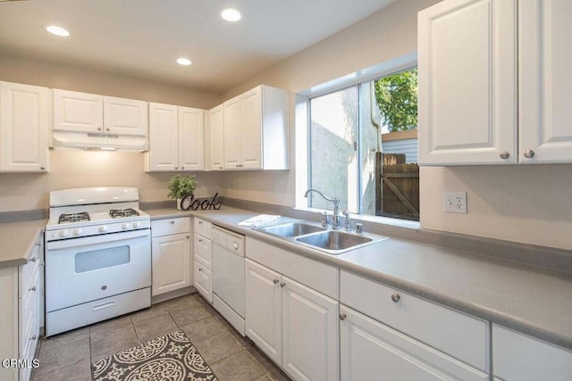 kitchen with white cabinetry, sink, and white appliances