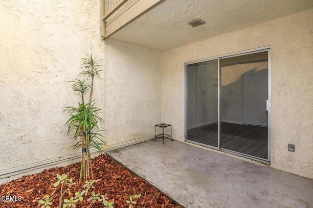 doorway to property featuring a patio