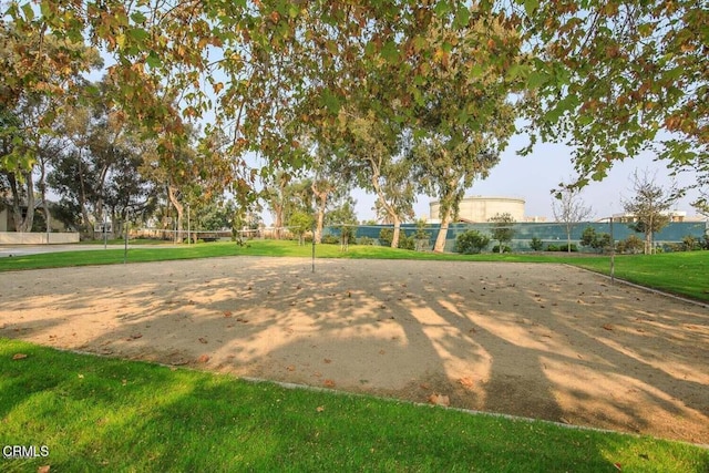 view of community featuring volleyball court and a yard