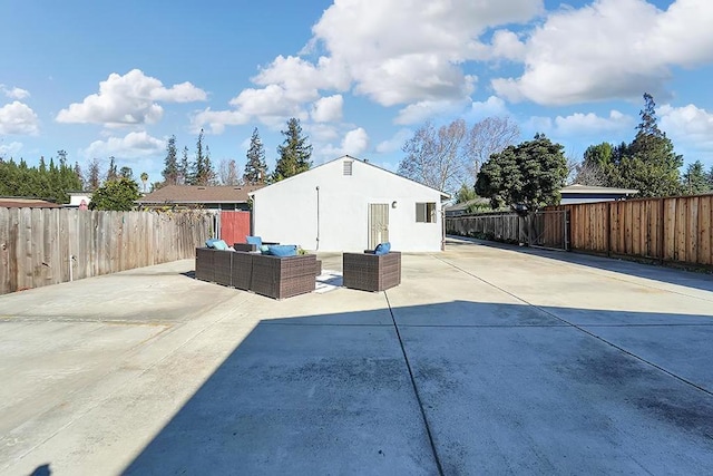 view of side of property with an outdoor living space and a patio area