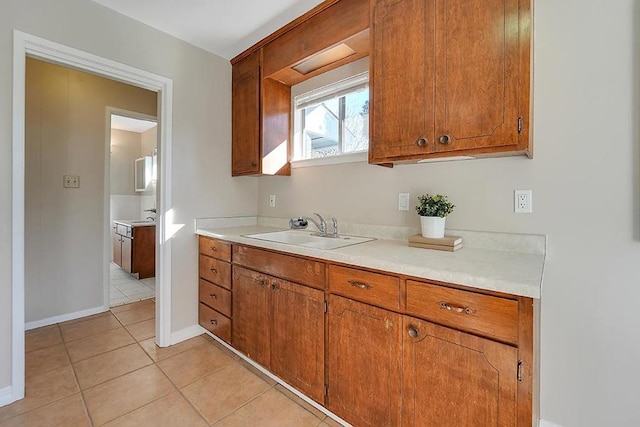 kitchen with sink and light tile patterned floors