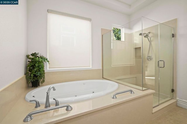 bathroom featuring plus walk in shower and tile patterned flooring