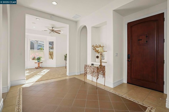 entryway with ceiling fan and tile patterned flooring