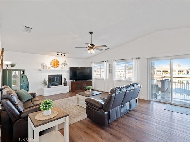 living room featuring ceiling fan, dark hardwood / wood-style floors, and lofted ceiling