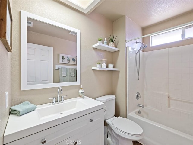 full bathroom with  shower combination, vanity, a textured ceiling, and toilet