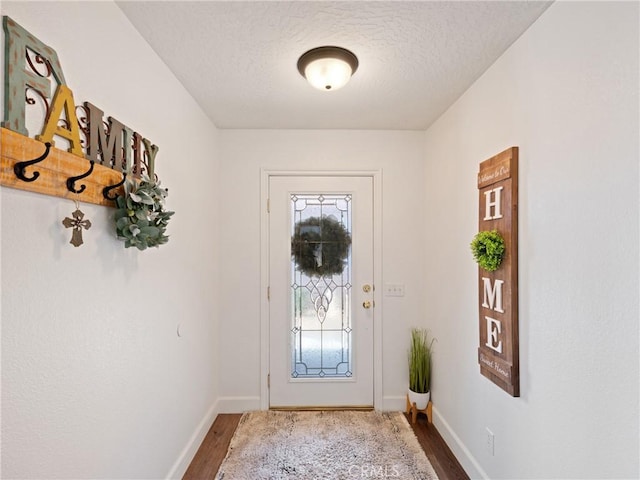 entryway featuring hardwood / wood-style flooring and a textured ceiling