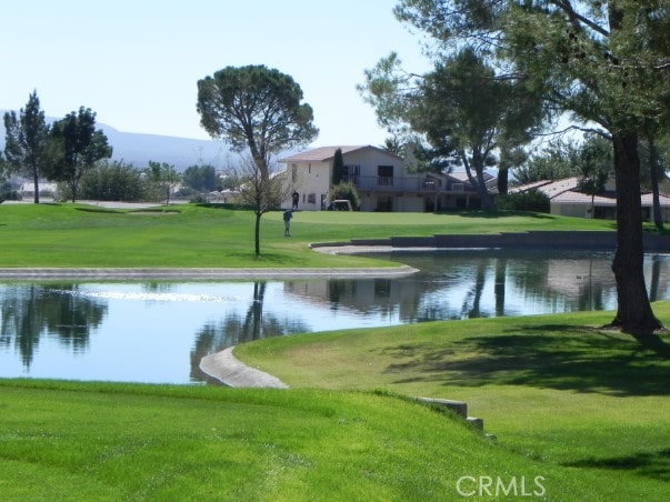 view of home's community with a yard and a water view