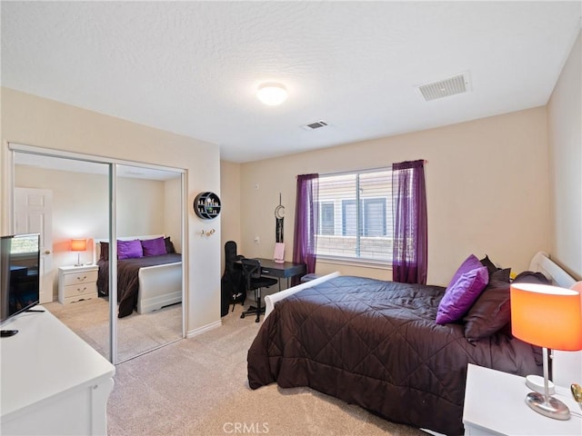 bedroom with light carpet and a closet