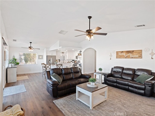 living room featuring ceiling fan and hardwood / wood-style floors