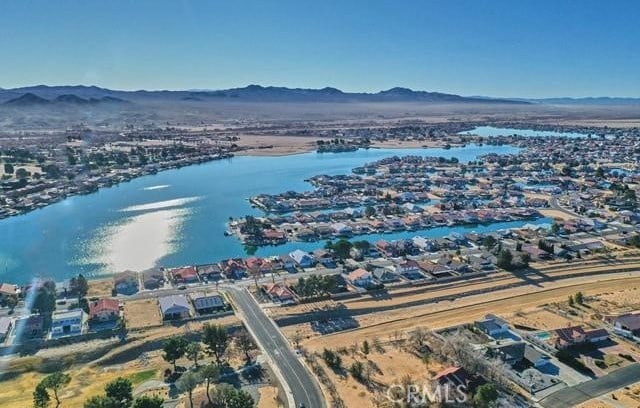 drone / aerial view with a water and mountain view