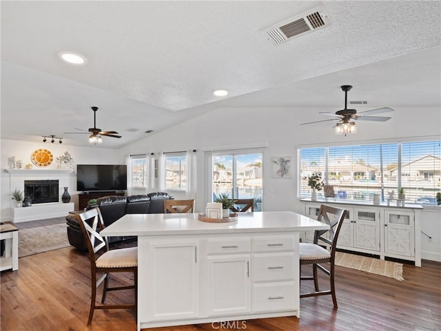 kitchen featuring a kitchen breakfast bar, white cabinetry, and a kitchen island