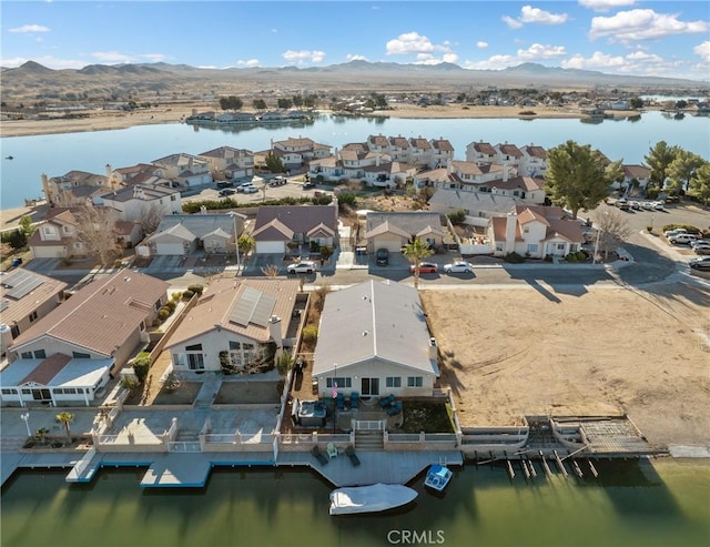 drone / aerial view with a water and mountain view