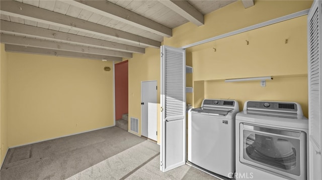 clothes washing area featuring light carpet, wooden ceiling, and independent washer and dryer