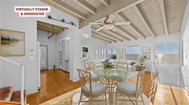 dining space featuring ceiling fan, light hardwood / wood-style floors, lofted ceiling with beams, and wooden ceiling