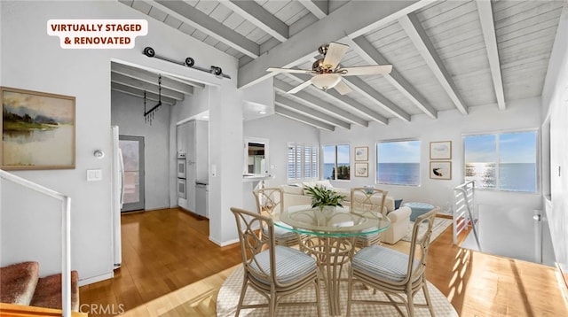 dining area featuring lofted ceiling with beams, hardwood / wood-style floors, wooden ceiling, and ceiling fan