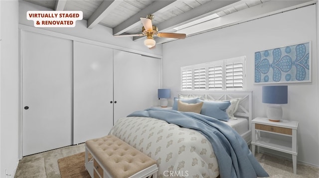 bedroom featuring ceiling fan, beam ceiling, and a closet