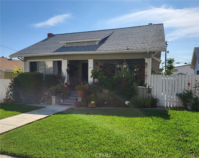 bungalow-style house with a front lawn