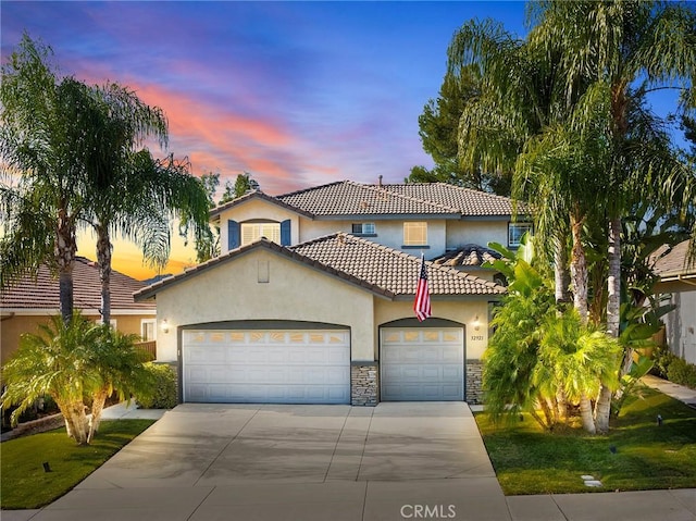 mediterranean / spanish-style home featuring a garage