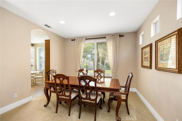 carpeted dining area featuring a healthy amount of sunlight