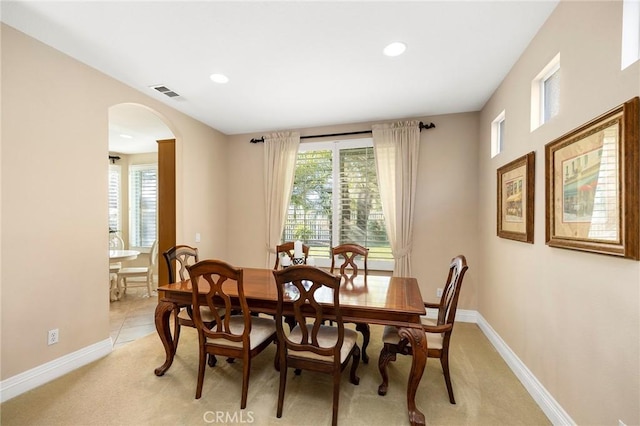 carpeted dining area featuring a wealth of natural light