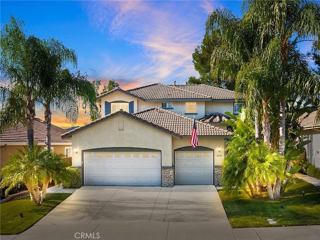 mediterranean / spanish home featuring a garage