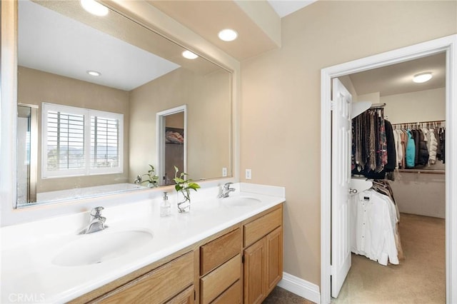 bathroom with a tub and vanity