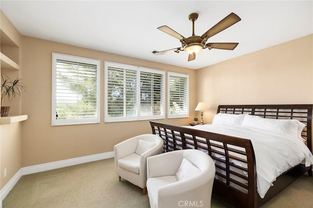 carpeted bedroom featuring ceiling fan and multiple windows