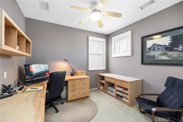 carpeted office space with ceiling fan