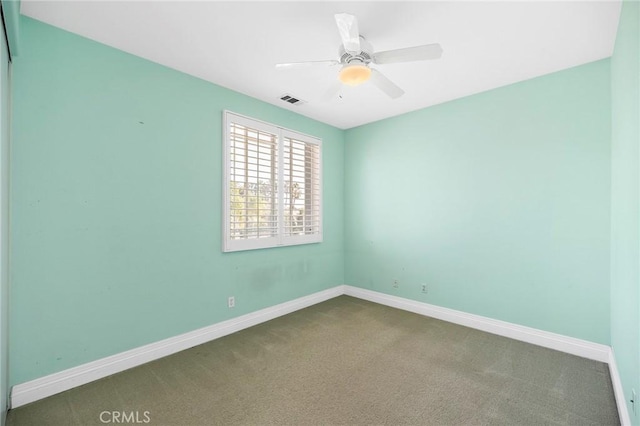 empty room featuring ceiling fan and light carpet