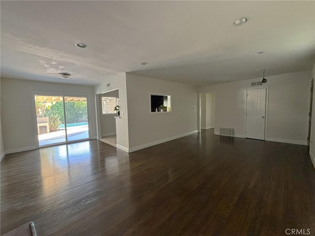 spare room featuring dark wood-type flooring