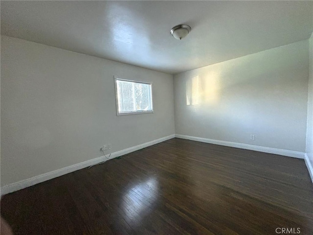 empty room featuring dark wood-type flooring