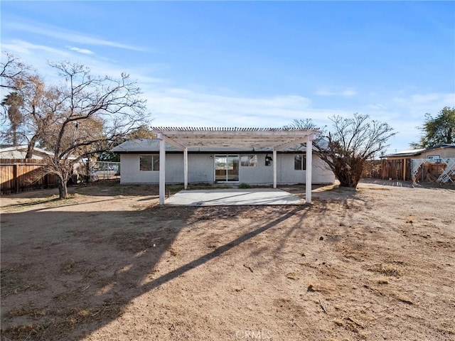 rear view of property featuring a patio and a pergola