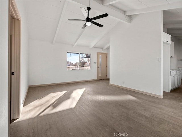 unfurnished living room featuring ceiling fan and lofted ceiling with beams