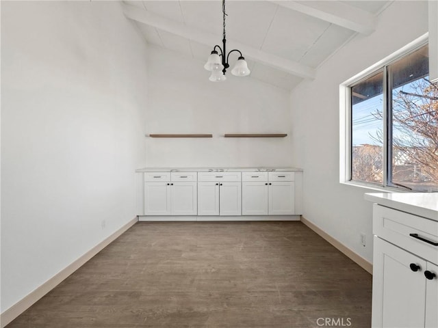 unfurnished dining area with vaulted ceiling with beams, an inviting chandelier, and hardwood / wood-style floors