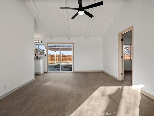 unfurnished living room featuring ceiling fan, sink, wood-type flooring, and lofted ceiling with beams