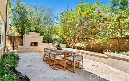 view of patio featuring exterior fireplace