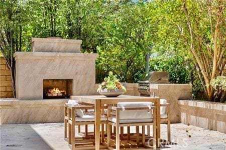 view of patio / terrace featuring an outdoor fireplace and area for grilling