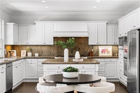 kitchen featuring stainless steel appliances, white cabinets, tasteful backsplash, and sink