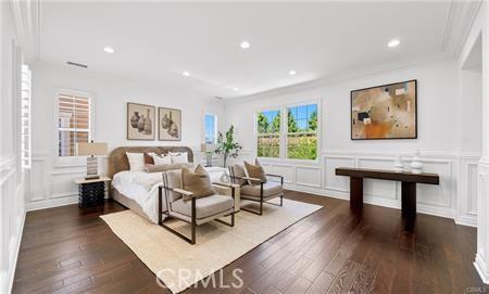 bedroom with dark wood-type flooring and ornamental molding