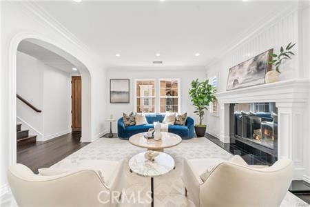 living room with hardwood / wood-style floors and crown molding